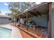 Outdoor living space featuring a wooden patio cover, built-in bar and gas grill at 12412 Lakeview Dr, Dade City, FL 33525