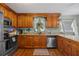 Beautiful kitchen featuring wooden cabinets, granite countertops, and stainless steel appliances at 12412 Lakeview Dr, Dade City, FL 33525