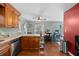 Open kitchen with granite countertops, wooden cabinetry, and an adjacent dining area at 12412 Lakeview Dr, Dade City, FL 33525