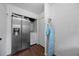 Convenient laundry area features stainless steel refrigerator and washer with dryer hookups at 12412 Lakeview Dr, Dade City, FL 33525
