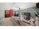 Spacious open-concept living room with sliding glass doors to the pool, a dining area, and sectional sofa at 12412 Lakeview Dr, Dade City, FL 33525
