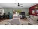 Bright living room with sliding glass doors to the pool, sectional sofa, and arcade game at 12412 Lakeview Dr, Dade City, FL 33525