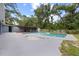 Backyard featuring a sparkling pool and a covered outdoor area at 12412 Lakeview Dr, Dade City, FL 33525