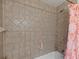 Shower featuring tiled walls and a shower head with bathtub and tiled walls at 12412 Lakeview Dr, Dade City, FL 33525