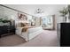 Spacious main bedroom with stone accent wall, large windows, and stylish decor with neutral color palette at 12782 Canter Call Rd, Lithia, FL 33547