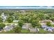 Aerial perspective of the property in lush surroundings with lake and neighborhood at 1332 Osceola Hollow Rd, Odessa, FL 33556
