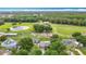 Expansive aerial view of horse property with pond, paddocks, outbuildings, and lush surrounding landscape at 1332 Osceola Hollow Rd, Odessa, FL 33556