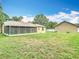 Lush backyard with a green lawn and detached garage, providing a private and serene outdoor space at 1332 Osceola Hollow Rd, Odessa, FL 33556