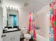 Bathroom featuring a combination tub and shower and single sink vanity with mirror at 1332 Osceola Hollow Rd, Odessa, FL 33556