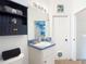 Bathroom featuring a vanity, sink, and storage shelves, with view to the kitchen at 1332 Osceola Hollow Rd, Odessa, FL 33556