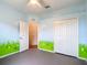 Bright bedroom featuring colorful mural, ceiling fan, and ample closet space at 1332 Osceola Hollow Rd, Odessa, FL 33556