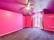 Bright pink bedroom featuring a ceiling fan and a window dressed with sheer curtains at 1332 Osceola Hollow Rd, Odessa, FL 33556