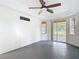 Bright bedroom features ceiling fan, tray ceiling and sliding glass doors to lanai at 1332 Osceola Hollow Rd, Odessa, FL 33556