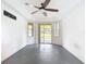 Spacious bedroom with tray ceiling, ceiling fan, and sliding glass doors to screened porch at 1332 Osceola Hollow Rd, Odessa, FL 33556