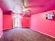 Pink bedroom with ceiling fan, unique lighting, window with curtains and carpet at 1332 Osceola Hollow Rd, Odessa, FL 33556
