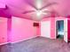 Pink bedroom featuring carpet flooring, ceiling fan, closet, and wall mounted TV at 1332 Osceola Hollow Rd, Odessa, FL 33556