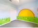 Bright bedroom featuring colorful mural, ceiling fan, and ample closet space at 1332 Osceola Hollow Rd, Odessa, FL 33556