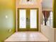 View of the front entrance with decorative glass doors and tile flooring at 1332 Osceola Hollow Rd, Odessa, FL 33556