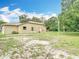 Exterior shot of the home showing the back of the property and the natural surroundings at 1332 Osceola Hollow Rd, Odessa, FL 33556