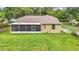 Exterior of the home showcasing the screened in lanai and backyard at 1332 Osceola Hollow Rd, Odessa, FL 33556