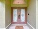 Elegant double front doors with decorative glass inserts and a welcoming 'Home Sweet Home' mat at 1332 Osceola Hollow Rd, Odessa, FL 33556