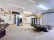 Spacious garage interior with overhead lighting, vehicle lift, and ample workspace at 1332 Osceola Hollow Rd, Odessa, FL 33556