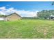 Detached two-car garage on a verdant lawn, perfect for storage or a workshop at 1332 Osceola Hollow Rd, Odessa, FL 33556
