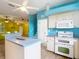 Kitchen with white appliances and blue walls at 1332 Osceola Hollow Rd, Odessa, FL 33556