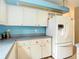 Close up view of the kitchen with white appliances and white cabinetry at 1332 Osceola Hollow Rd, Odessa, FL 33556