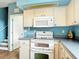 The kitchen features bright white appliances and white cabinetry at 1332 Osceola Hollow Rd, Odessa, FL 33556
