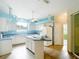 Modern kitchen with white cabinets, blue accents, and a breakfast bar at 1332 Osceola Hollow Rd, Odessa, FL 33556