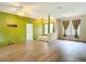 Inviting living room featuring wood-look floors, ceiling fan, and bright natural light at 1332 Osceola Hollow Rd, Odessa, FL 33556