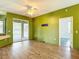 Open living room with wood-look floors, sliding glass doors, and access to the patio at 1332 Osceola Hollow Rd, Odessa, FL 33556