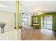 Open-concept living area featuring wood-look flooring and access to the kitchen and outdoor patio at 1332 Osceola Hollow Rd, Odessa, FL 33556