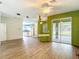 Spacious living area with wood-look flooring, seamlessly connecting to the kitchen and outdoor space at 1332 Osceola Hollow Rd, Odessa, FL 33556