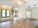 View of the living room featuring wood-look flooring, an arched entryway, and neutral wall paint at 1332 Osceola Hollow Rd, Odessa, FL 33556