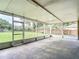 Large screened-in porch with view of grassy yard and fence line at 1332 Osceola Hollow Rd, Odessa, FL 33556