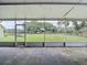 Spacious screened-in porch overlooking a large grassy yard and mature trees at 1332 Osceola Hollow Rd, Odessa, FL 33556