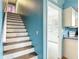 Staircase with white risers and stained treads, leading to a room with shelving at 1332 Osceola Hollow Rd, Odessa, FL 33556