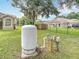 A tank sits in the grassy yard with a fenced perimeter, offering space and security at 1332 Osceola Hollow Rd, Odessa, FL 33556