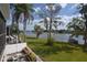 Well-manicured backyard with a waterfront view and boat docked nearby at 13758 Orange Sunset Dr # 202, Tampa, FL 33618