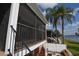 Backyard patio and staircase with waterfront view and landscaping at 13758 Orange Sunset Dr # 202, Tampa, FL 33618