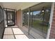 Spacious screened-in balcony with brick exterior and room for outdoor seating at 13758 Orange Sunset Dr # 202, Tampa, FL 33618