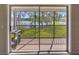 Screened balcony with scenic view of the lake and surrounding greenery at 13758 Orange Sunset Dr # 202, Tampa, FL 33618