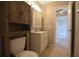 Well-lit bathroom featuring a toilet and vanity with a cabinet below and mirrored cabinet above at 13758 Orange Sunset Dr # 202, Tampa, FL 33618