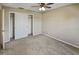 Neutral bedroom with carpet, ceiling fan with lights, and a closet with sliding doors at 13758 Orange Sunset Dr # 202, Tampa, FL 33618