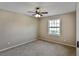 Bedroom featuring neutral walls, carpet, window, and ceiling fan with lights at 13758 Orange Sunset Dr # 202, Tampa, FL 33618