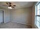 Neutral bedroom featuring carpet, a ceiling fan with lights, and a window at 13758 Orange Sunset Dr # 202, Tampa, FL 33618