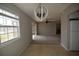 Dining area open to the living room, and featuring tile floors and a modern chandelier at 13758 Orange Sunset Dr # 202, Tampa, FL 33618