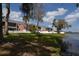 Waterfront condos with screened porches and a bench overlooking the lake at 13758 Orange Sunset Dr # 202, Tampa, FL 33618
